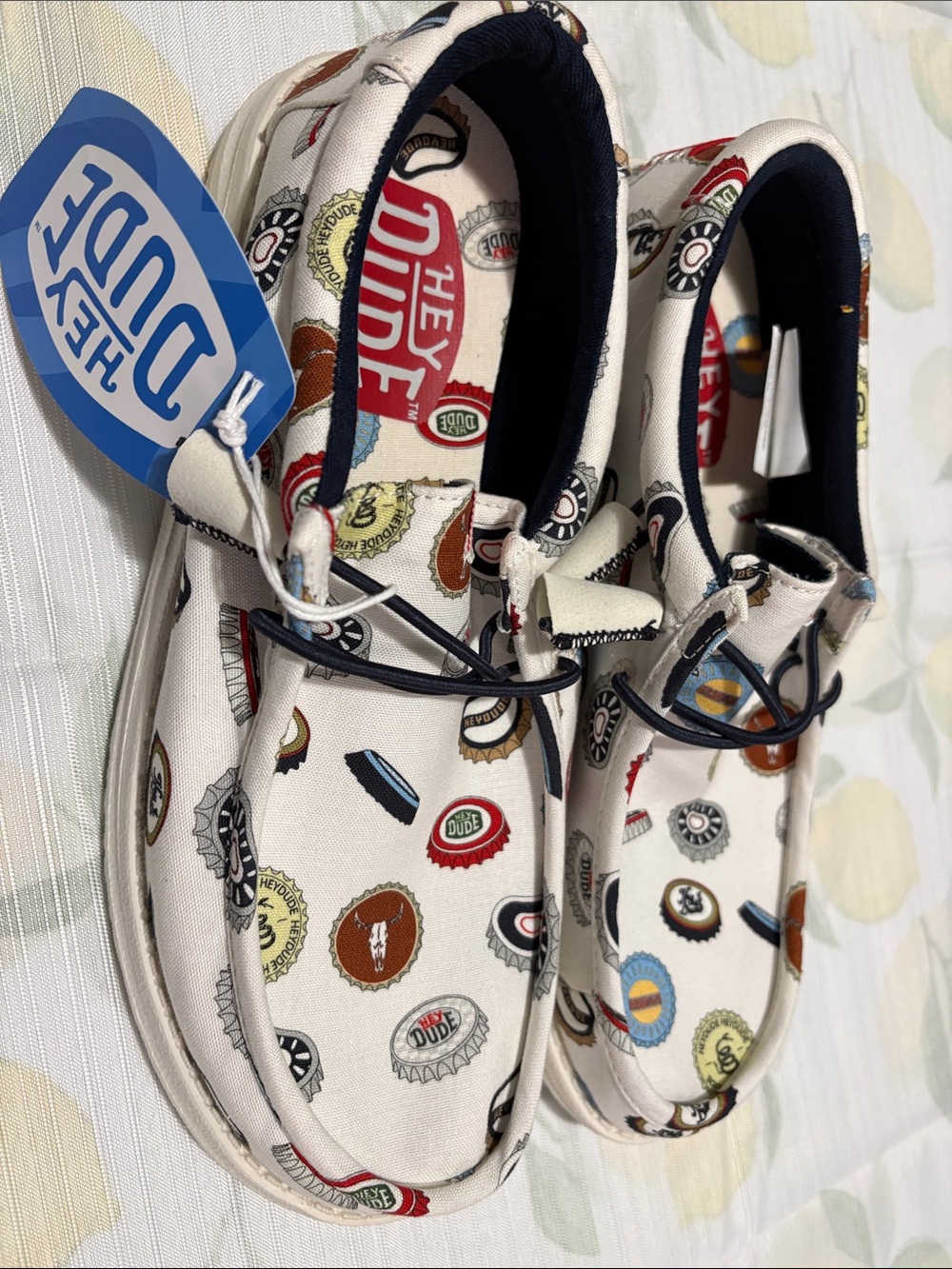 Hey Dude White Slip-On Loafers with Multicolor Bottle Cap Print